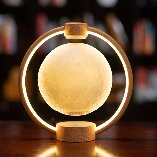 Levitating Moon Lamp with wooden frame and warm yellow glowing moon