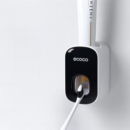 Wall-mounted Ecoco automatic toothpaste dispenser with toothbrush, clean white background
